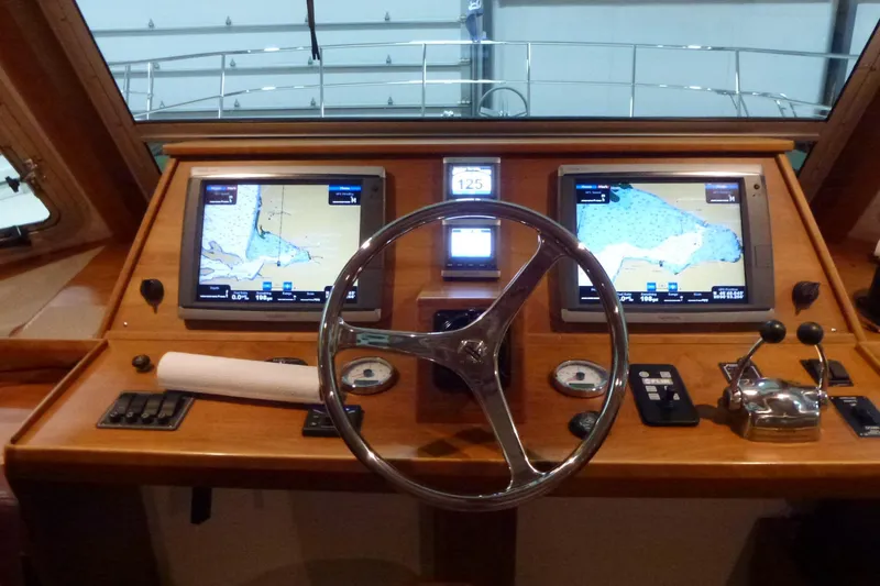 Slide: The Image of Cockpit of 2009 Maine Cat P-47 with navigation screens and steering wheel. - 19