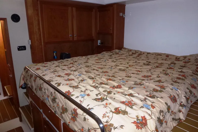 Slide: The Image of Cozy cabin bed in 2009 Maine Cat P-47 with floral bedding and wooden cabinetry. - 21