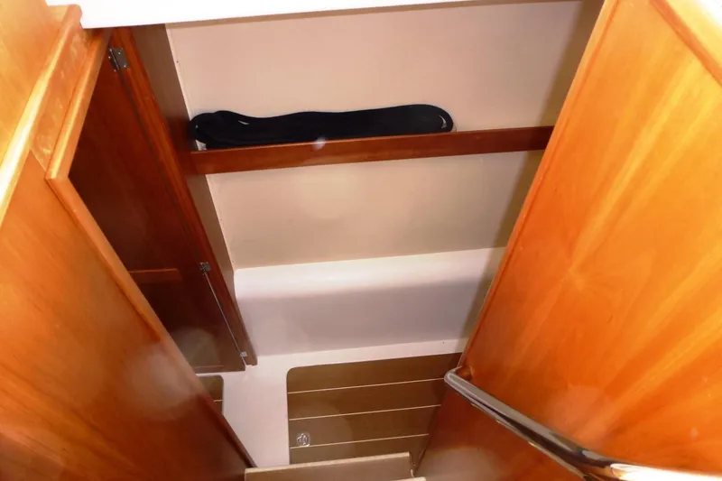 Slide: The Image of Interior view of 2009 Maine Cat P-47, featuring wooden cabinetry and steps. - 24