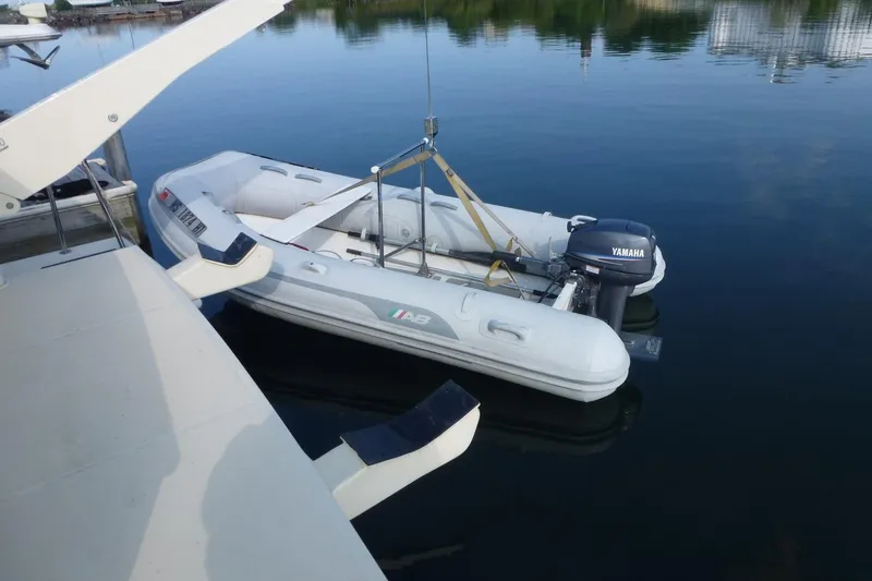 Slide: The Image of Inflatable boat with Yamaha motor docked on calm water. - 28