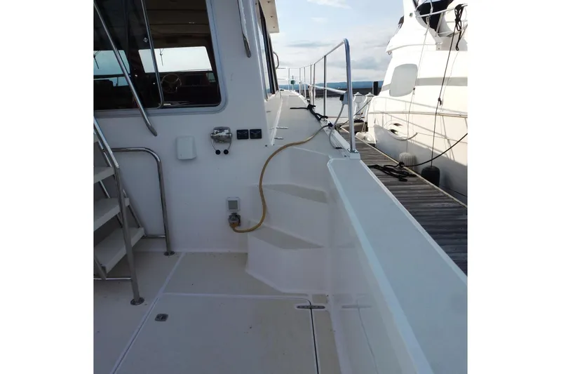 Slide: The Image of 2009 Maine Cat P-47 yacht docked, showcasing side deck and railing. - 7