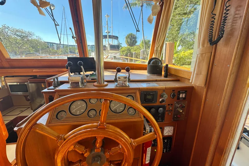 Slide: The Image of Interior of 1990 Grand Banks 46 Classic yacht with wooden helm and seating area. - 11