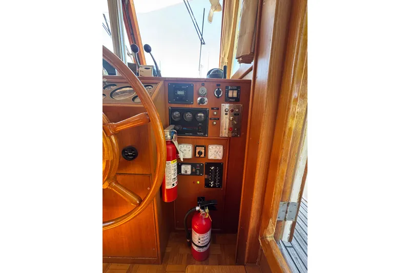 Slide: The Image of Helm of 1990 Grand Banks 46 Classic yacht with wooden wheel and navigation instruments. - 15