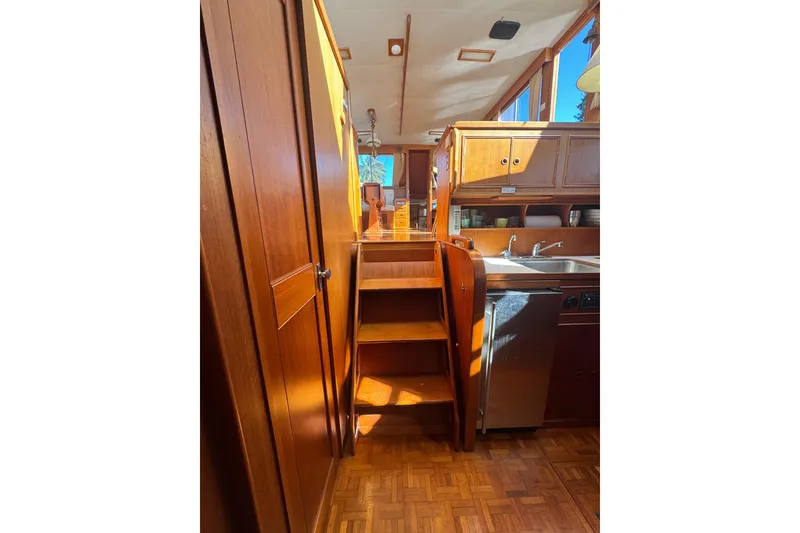 Slide: The Image of 1990 Grand Banks 46 Classic yacht interior with wood finish and modern kitchen appliances. - 18