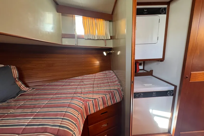 Slide: The Image of 1990 Grand Banks 46 Classic yacht interior with wood paneling and laundry area. - 27