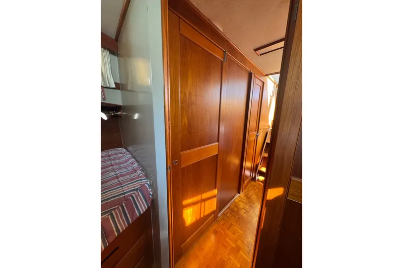 Slide: The Image of Cozy cabin interior of 1990 Grand Banks 46 Classic yacht with striped bedding. - 34