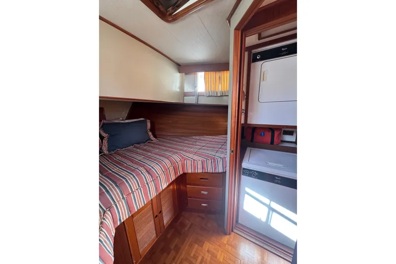 Slide: The Image of Interior of 1990 Grand Banks 46 Classic yacht with wooden paneling and cozy cabin. - 35