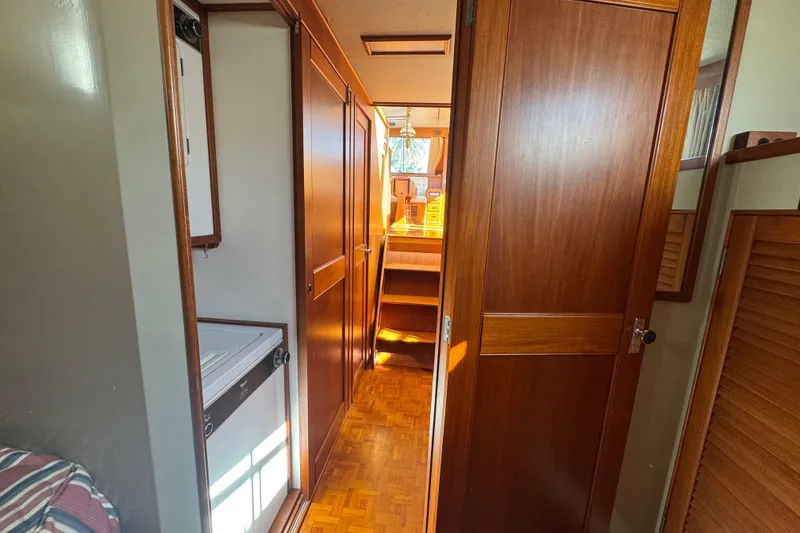 Slide: The Image of Cozy cabin interior of 1990 Grand Banks 46 Classic with bed and laundry area. - 36