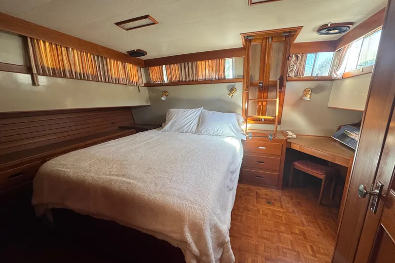 Slide: The Image of Cozy bedroom interior of 1990 Grand Banks 46 Classic yacht with wooden accents and stairs. - 44