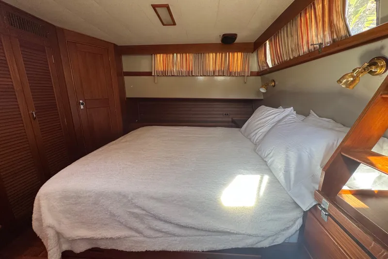 Slide: The Image of Cozy bedroom in 1990 Grand Banks 46 Classic yacht with wood accents and natural light. - 45