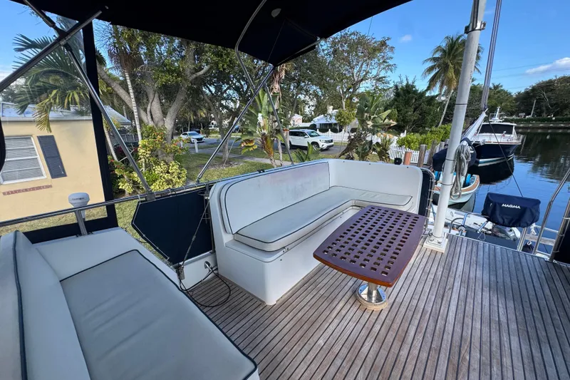 Slide: The Image of Helm of 1990 Grand Banks 46 Classic yacht with wooden wheel and navigation equipment. - 51