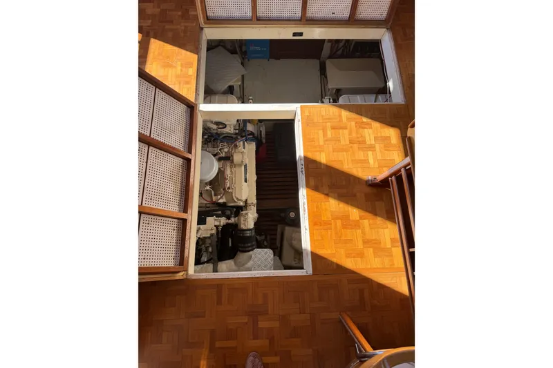 Slide: The Image of Grand Banks 46 Classic yacht docked in a serene canal, surrounded by lush greenery. - 56