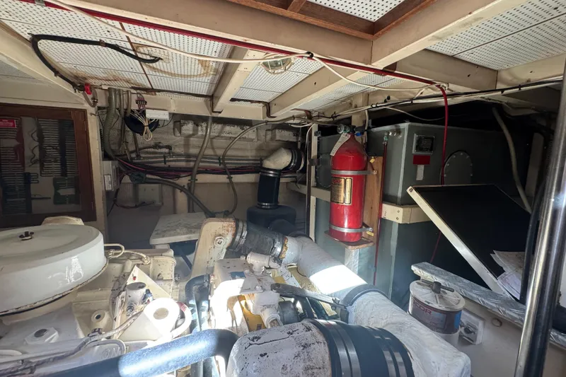 Slide: The Image of Engine room of 1990 Grand Banks 46 Classic with fire extinguisher and equipment. - 59