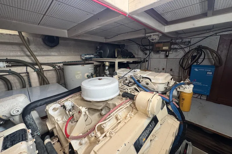 Slide: The Image of Engine room of 1990 Grand Banks 46 Classic yacht, featuring dual engines and equipment. - 65