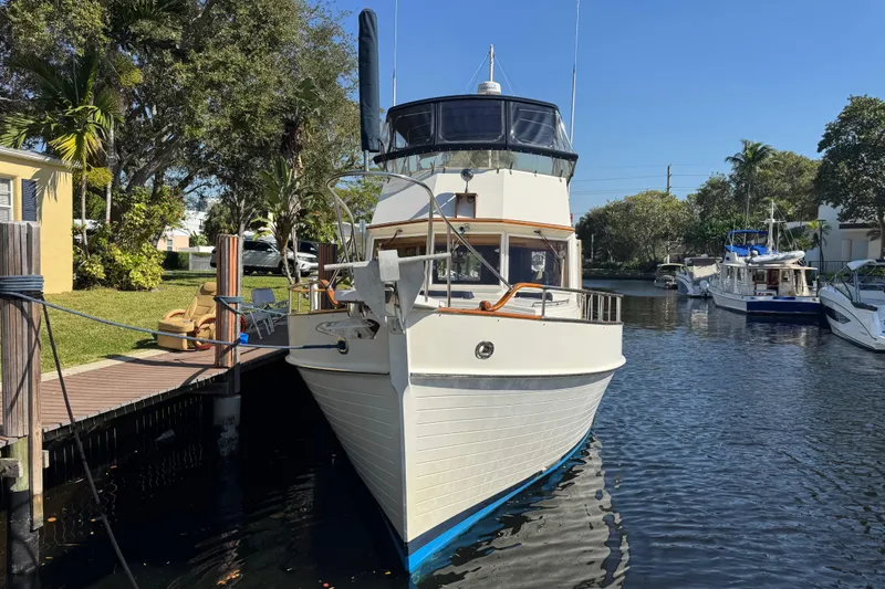 Slide: The Image of Engine room of a 1990 Grand Banks 46 Classic yacht, featuring machinery and fire extinguisher. - 67