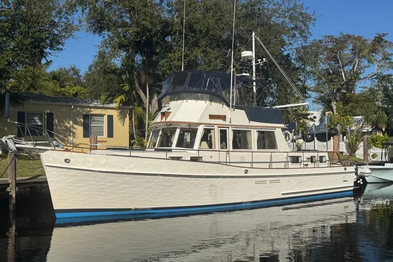 Slide: The Image of 1990 Grand Banks 46 Classic yacht docked in a serene marina setting. - 68