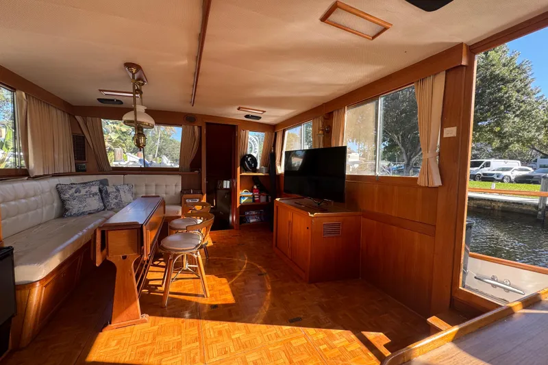 Slide: The Image of Interior of a 1990 Grand Banks 46 Classic yacht with wooden furnishings and seating area. - 8