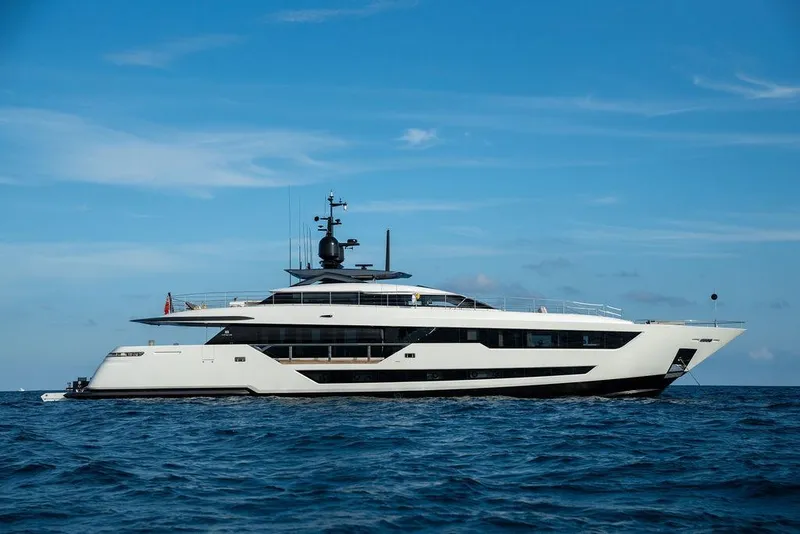 Slide: The Image of Luxurious 2018 Custom Line 120 yacht cruising on open sea under clear blue sky. - 1