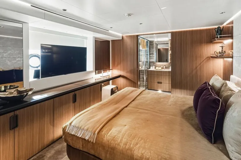 Slide: The Image of Luxurious bedroom interior on 2018 Custom Line 120 yacht, featuring elegant wood paneling and modern decor. - 102