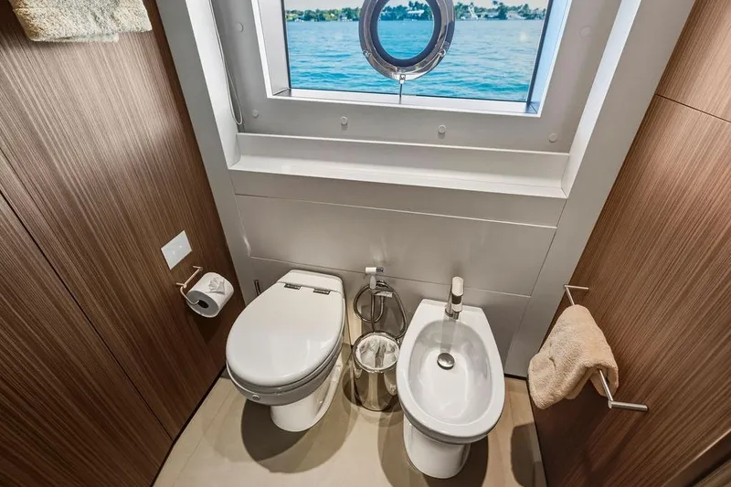 Slide: The Image of Luxurious yacht bathroom with toilet, bidet, and ocean view porthole, Custom Line 120, 2018. - 109