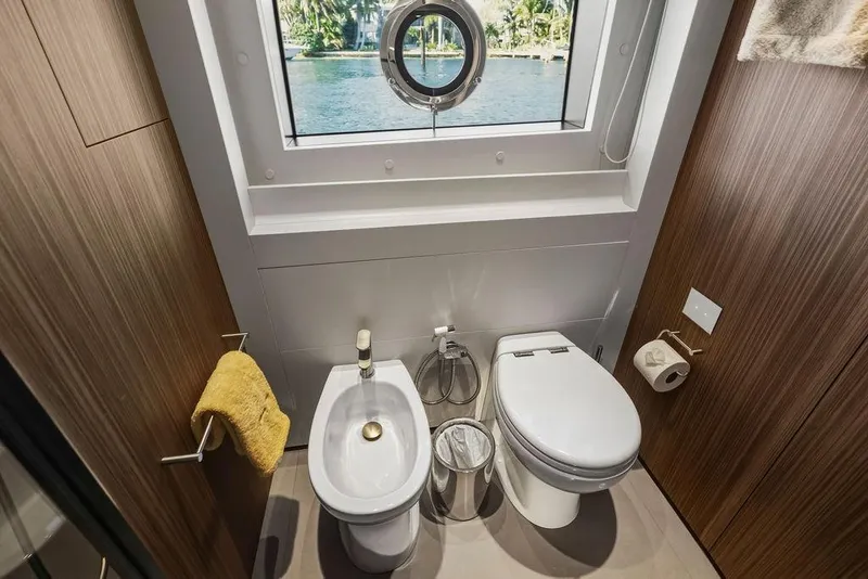 Slide: The Image of Luxurious yacht bathroom with toilet, bidet, and ocean view window, Custom Line 120, 2018 model. - 115