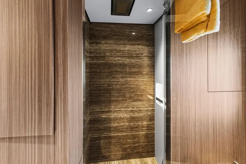 Slide: The Image of Luxurious Custom Line 120 yacht interior with wood paneling and marble accents, 2018 model. - 116