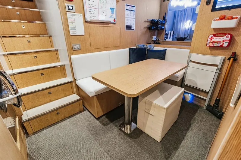 Slide: The Image of Cozy yacht interior with wooden stairs, dining area, and first aid kit, Custom Line 120, 2018. - 117