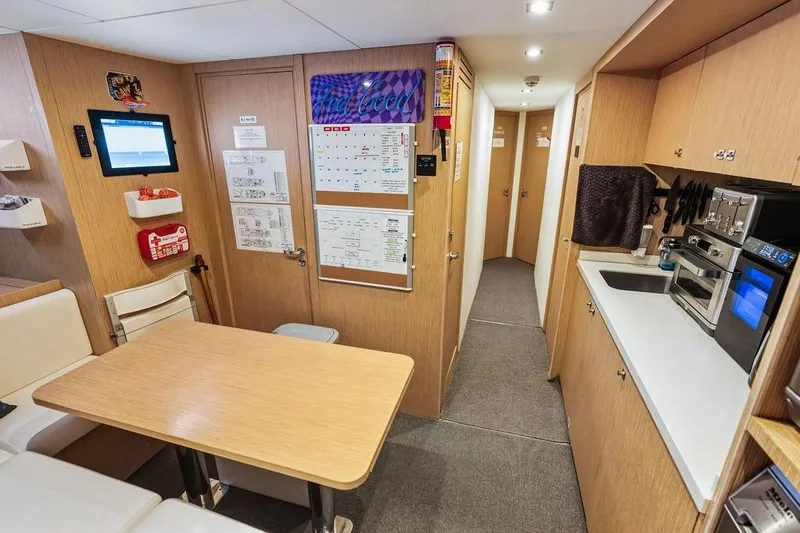 Slide: The Image of Modern yacht interior with dining area, kitchen, and hallway. Custom Line 120, 2018 model. - 118