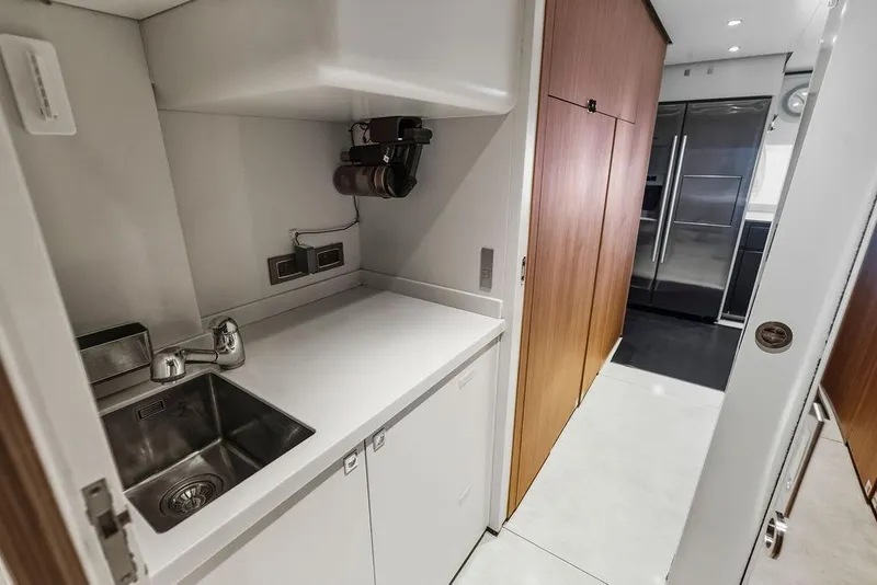 Slide: The Image of Modern yacht kitchen with sleek design, stainless steel sink, and wooden cabinetry, Custom Line 120, 2018. - 122