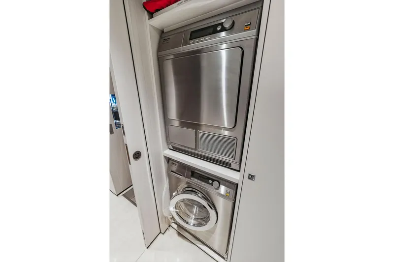 Slide: The Image of Stacked washer and dryer in a compact laundry space, Custom Line 120, 2018 model. - 123