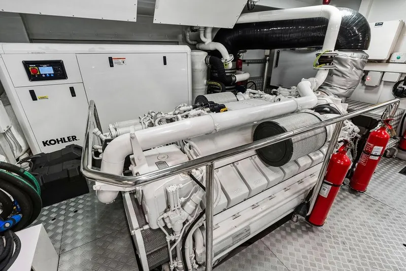 Slide: The Image of Engine room of a 2018 Custom Line 120 yacht with Kohler generator and fire extinguishers. - 125