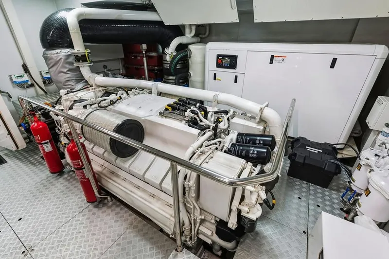 Slide: The Image of Engine room of 2018 Custom Line 120 yacht with fire extinguishers and control panel. - 127