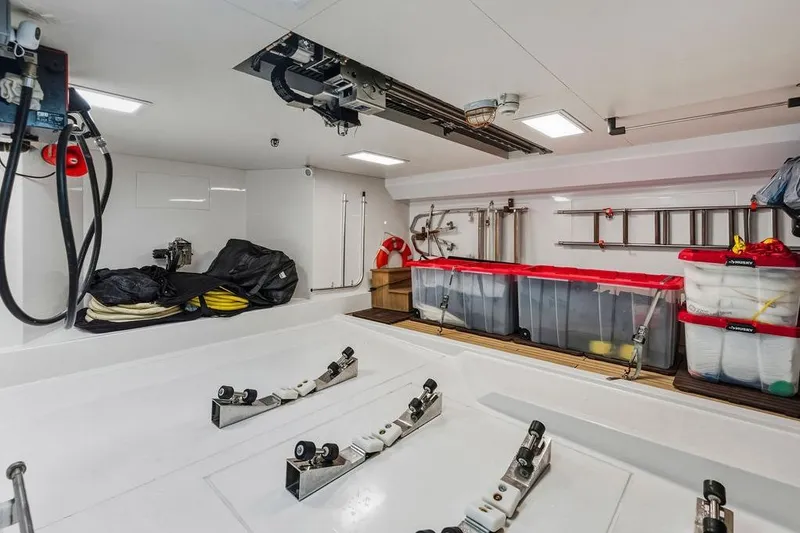 Slide: The Image of Spacious 2018 Custom Line 120 yacht storage area with organized equipment and containers. - 132
