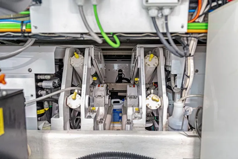 Slide: The Image of Engine compartment of a 2018 Custom Line 120 yacht, showcasing mechanical components and wiring. - 133