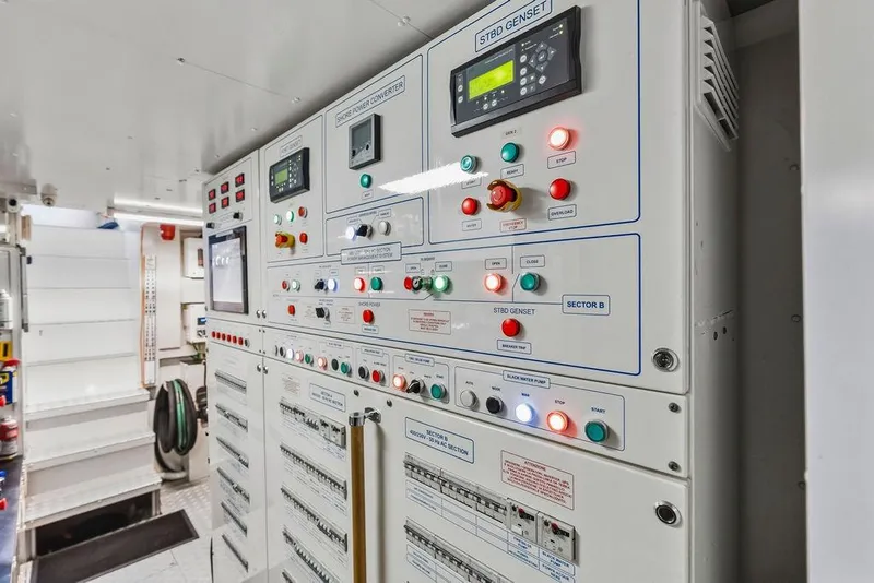 Slide: The Image of Control panel in a 2018 Custom Line 120 yacht, featuring various switches and indicators. - 136