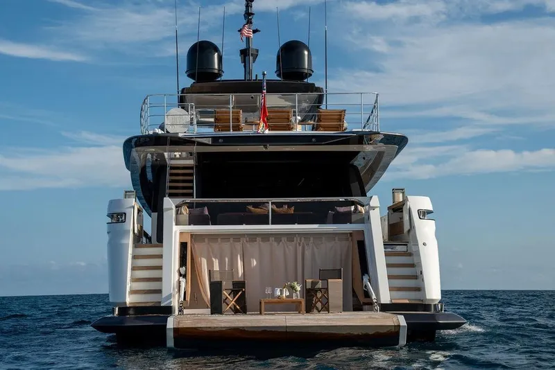 Slide: The Image of Luxurious 2018 Custom Line 120 yacht on open sea, rear view with elegant deck. - 16