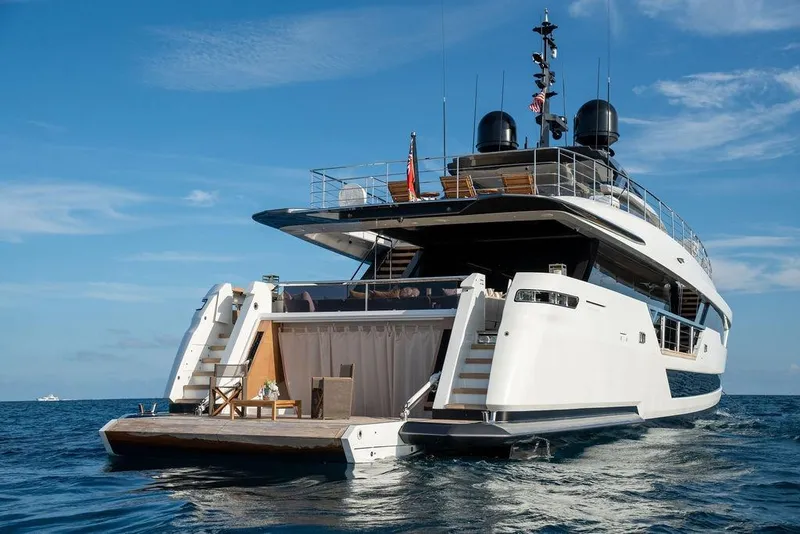 Slide: The Image of Luxury Custom Line 120 yacht, 2018 model, cruising on open sea under clear blue sky. - 17