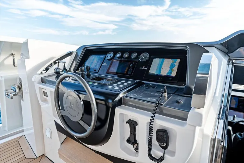 Slide: The Image of Helm of 2018 Custom Line 120 yacht with advanced navigation controls and displays. - 40