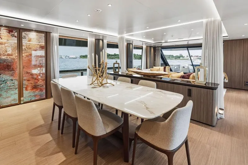 Slide: The Image of Luxurious 2018 Custom Line 120 yacht interior with elegant dining area and scenic ocean view. - 48