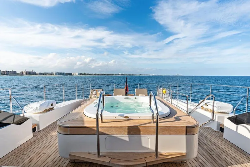 Slide: The Image of Luxurious 2018 Custom Line 120 yacht with jacuzzi, ocean view, and clear blue sky. - 59