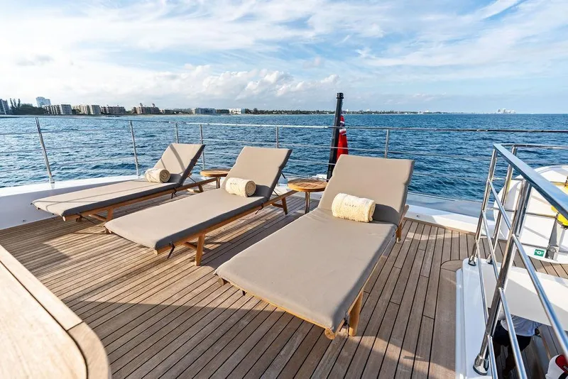 Slide: The Image of Luxurious 2018 Custom Line 120 yacht deck with sun loungers and ocean view. - 61