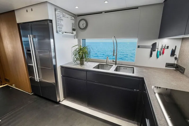 Slide: The Image of Modern yacht kitchen with ocean view, stainless steel appliances, and sleek cabinetry. Custom Line 120, 2018. - 64