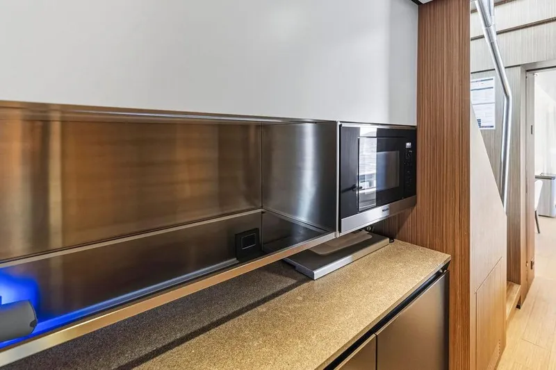 Slide: The Image of Modern kitchen area in 2018 Custom Line 120 yacht with sleek microwave and cabinetry. - 70