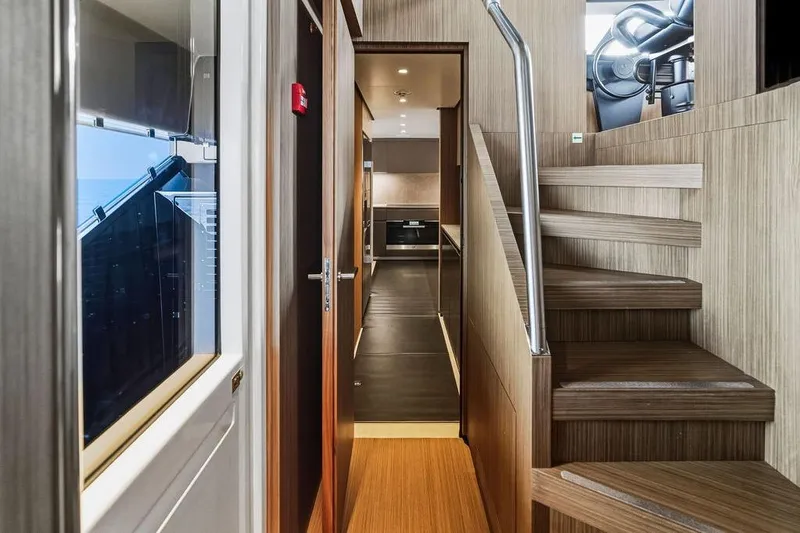 Slide: The Image of Interior of 2018 Custom Line 120 yacht, featuring modern wood staircase and sleek hallway design. - 71