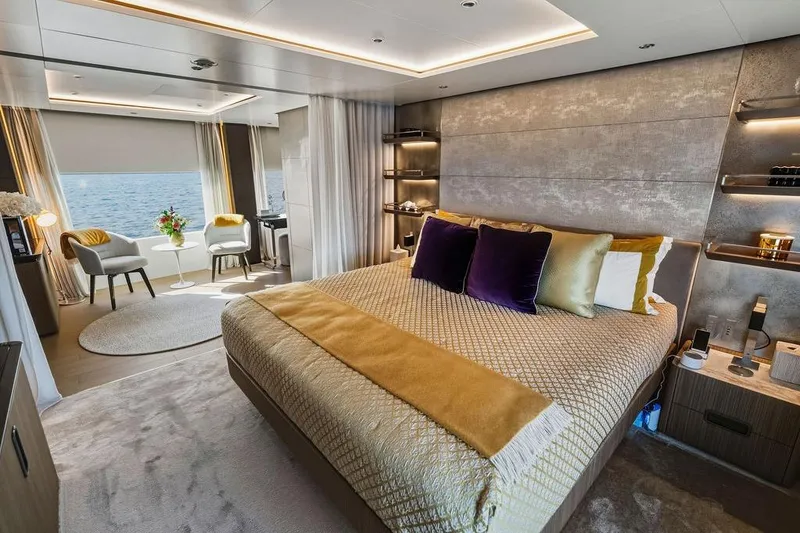 Slide: The Image of Luxurious 2018 Custom Line 120 yacht bedroom with ocean view, elegant decor, and plush bedding. - 76