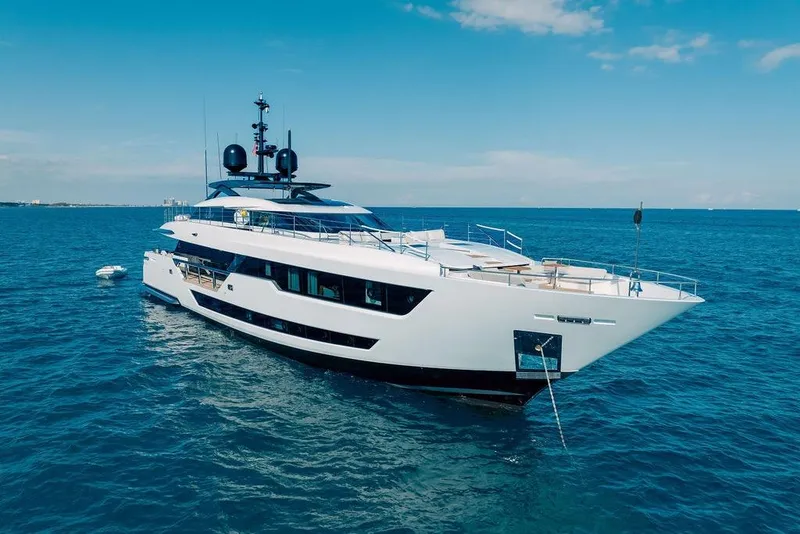 Slide: The Image of Luxurious 2018 Custom Line 120 yacht anchored in clear blue ocean waters. - 8