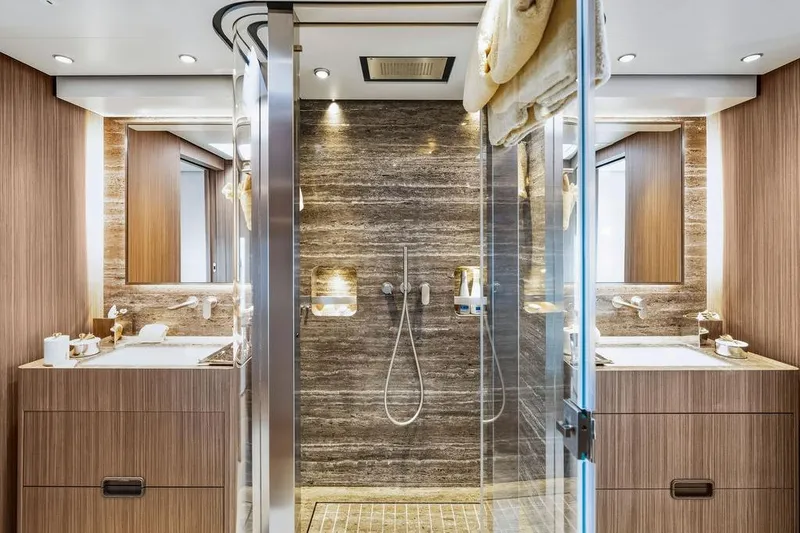 Slide: The Image of Luxurious yacht bathroom with dual sinks, glass shower, and elegant wood paneling, Custom Line 120, 2018. - 81