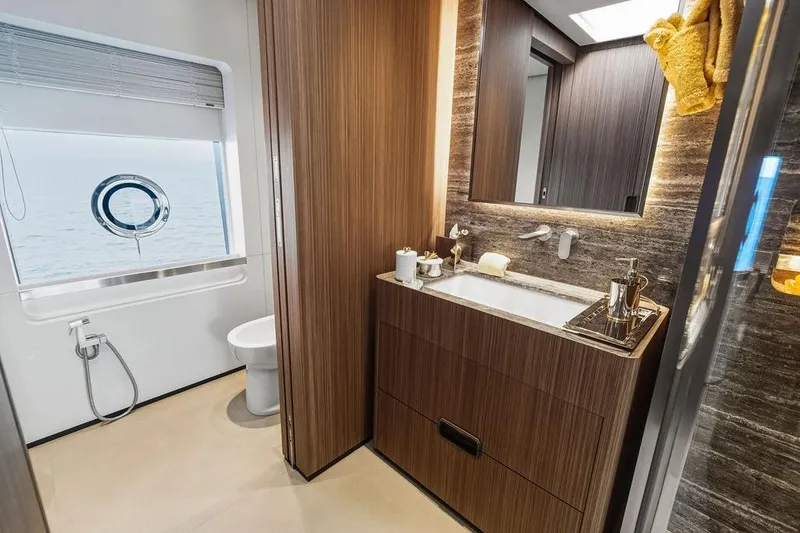 Slide: The Image of Luxurious yacht bathroom with wood accents, modern fixtures, and ocean view window, Custom Line 120, 2018. - 83