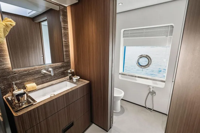 Slide: The Image of Luxurious yacht bathroom with wood accents, ocean view, and modern fixtures, Custom Line 120, 2018. - 84