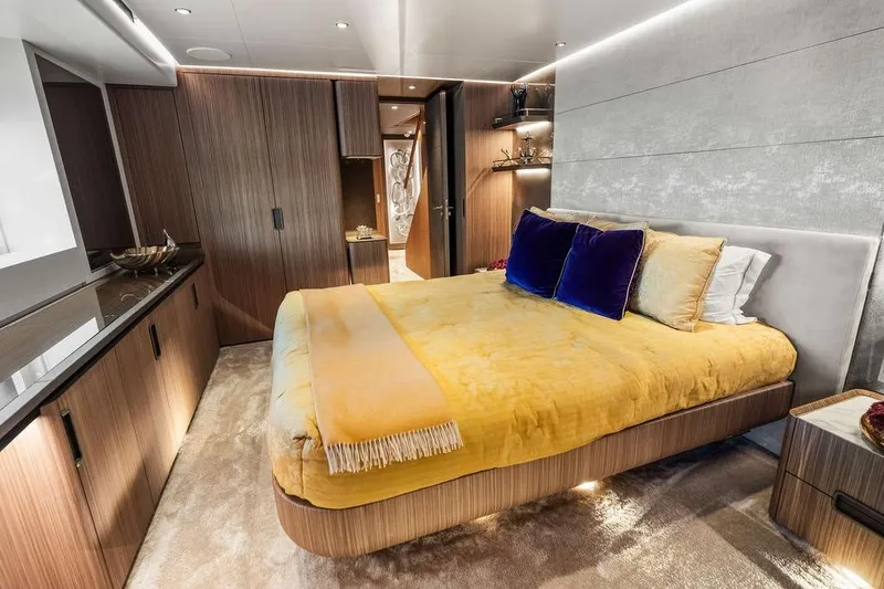 Slide: The Image of Luxurious yacht bedroom with modern design, featuring a plush bed and elegant wood paneling. - 90
